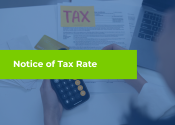 Hands holding a calculator over documents labeled “TAX,” with a bright green banner across the center that reads “Notice of Tax Rate.”